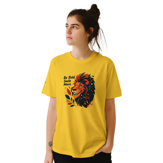 Female model wearing a yellow T-shirt with a lion illustration and slogan “Be Bold Stay Strong,” front view.