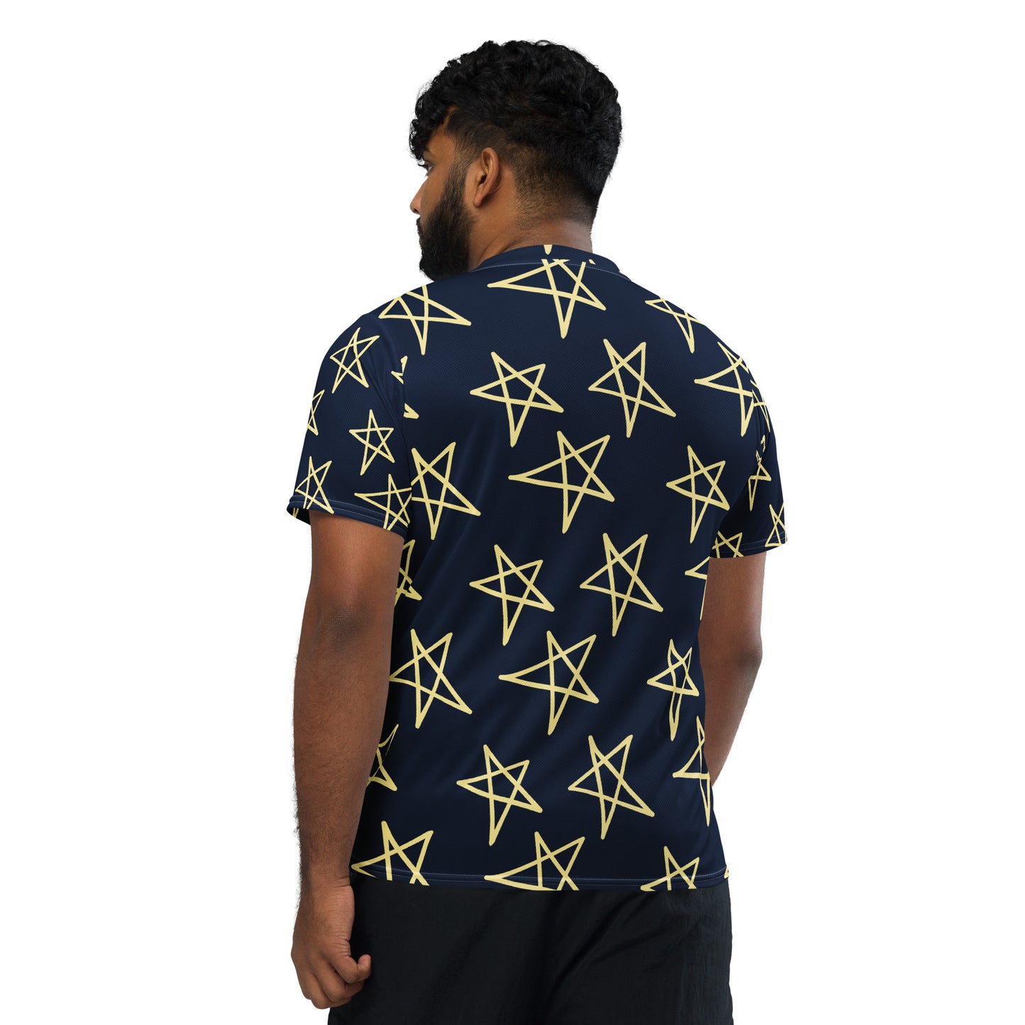 Navy short-sleeve shirt with yellow star pattern, side view on model.