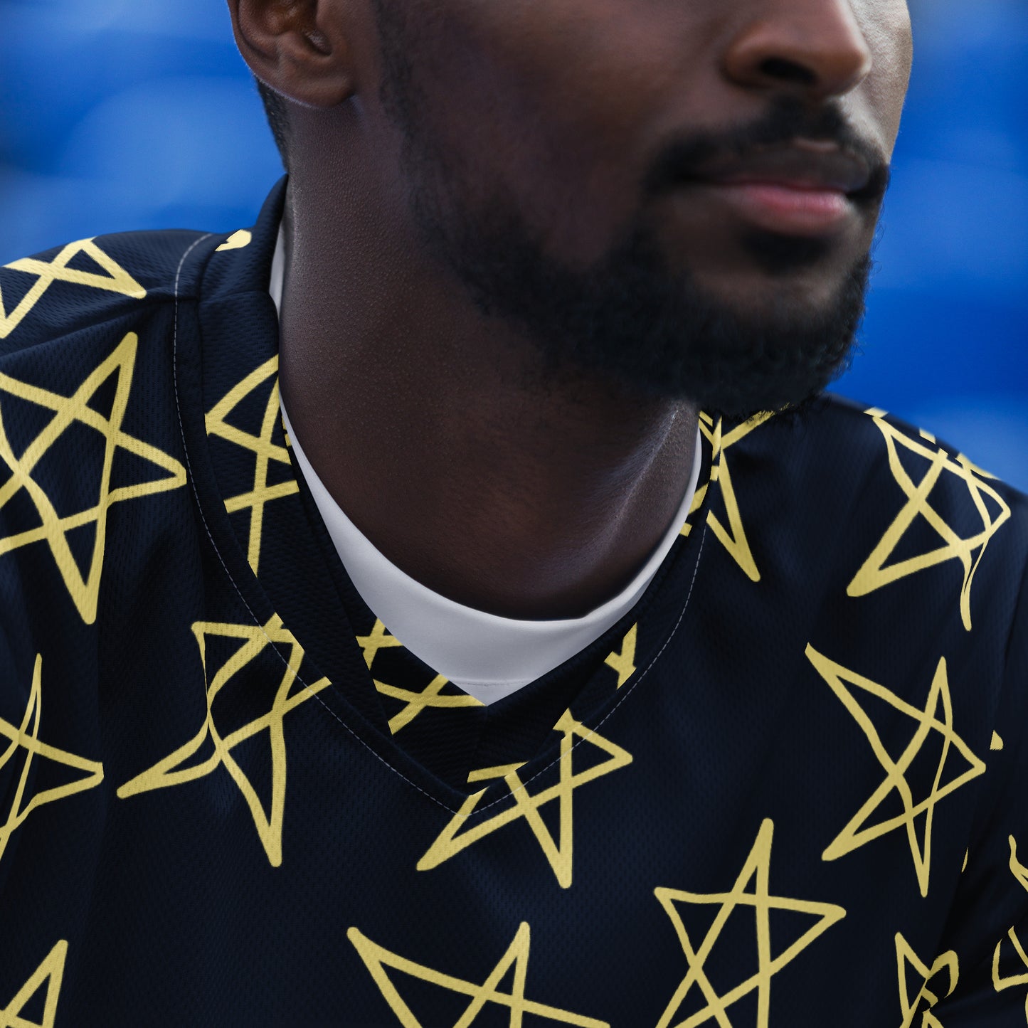 Navy short-sleeve shirt with yellow star pattern, back view without model.