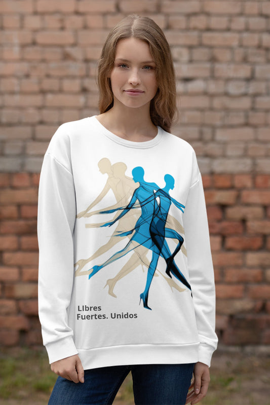 Female model wearing white sweatshirt — front print: abstract overlapping human figures in blue and beige with text Libres Fuertes Unidos
