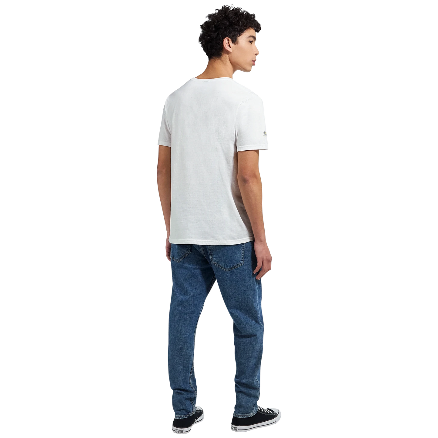 Male model wearing a white T-shirt with a chimpanzee illustration and slogan “Be Wild Stay Free,” back view.