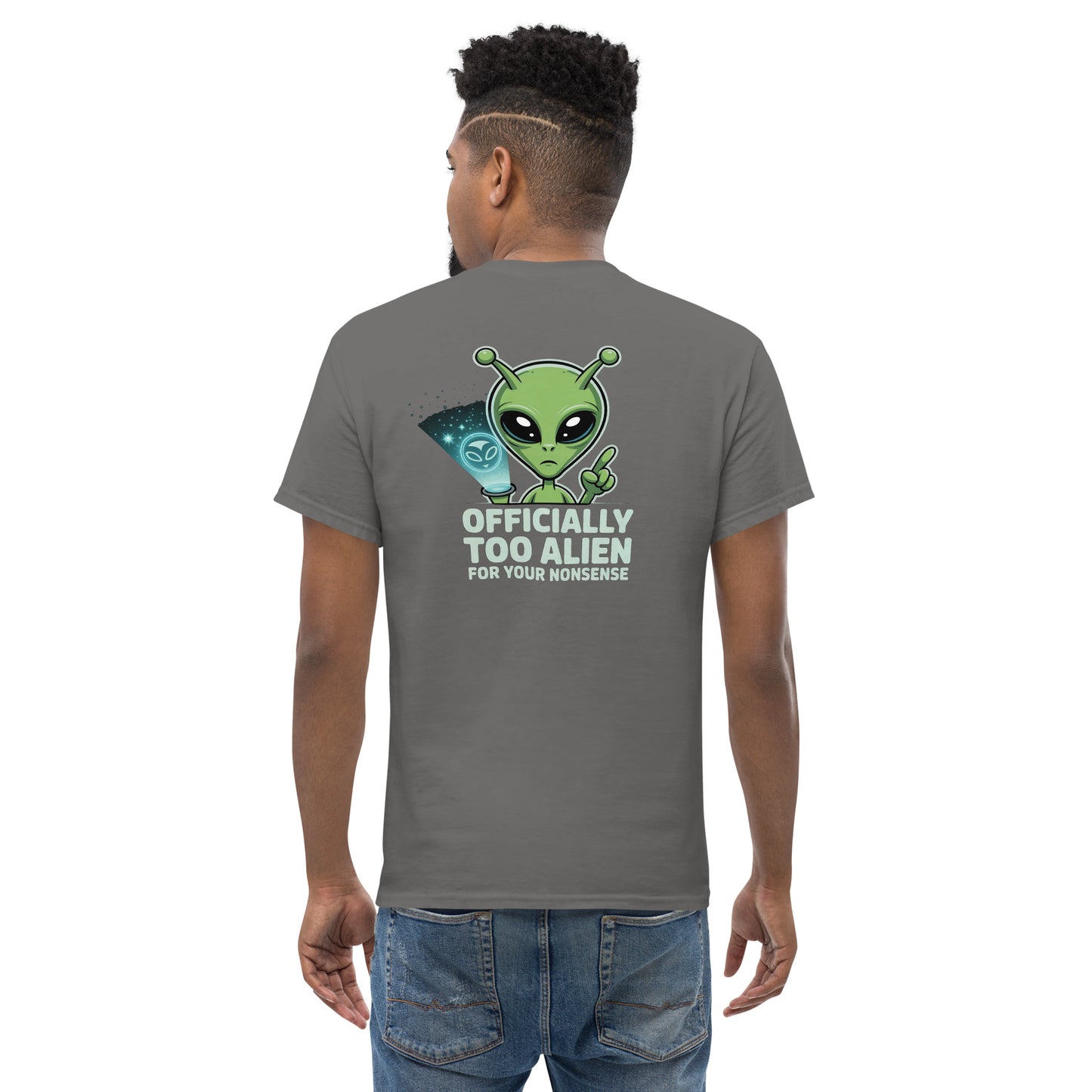 Male model wearing blue T-shirt — back print: green alien with text OFFICIALLY TOO ALIEN FOR YOU HUMANS