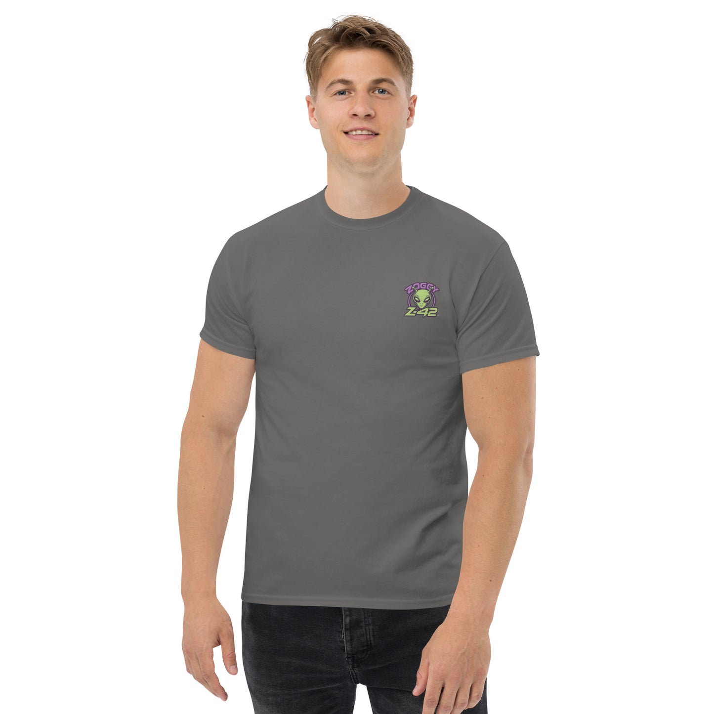 Male model wearing grey T-shirt — front left chest small alien head graphic