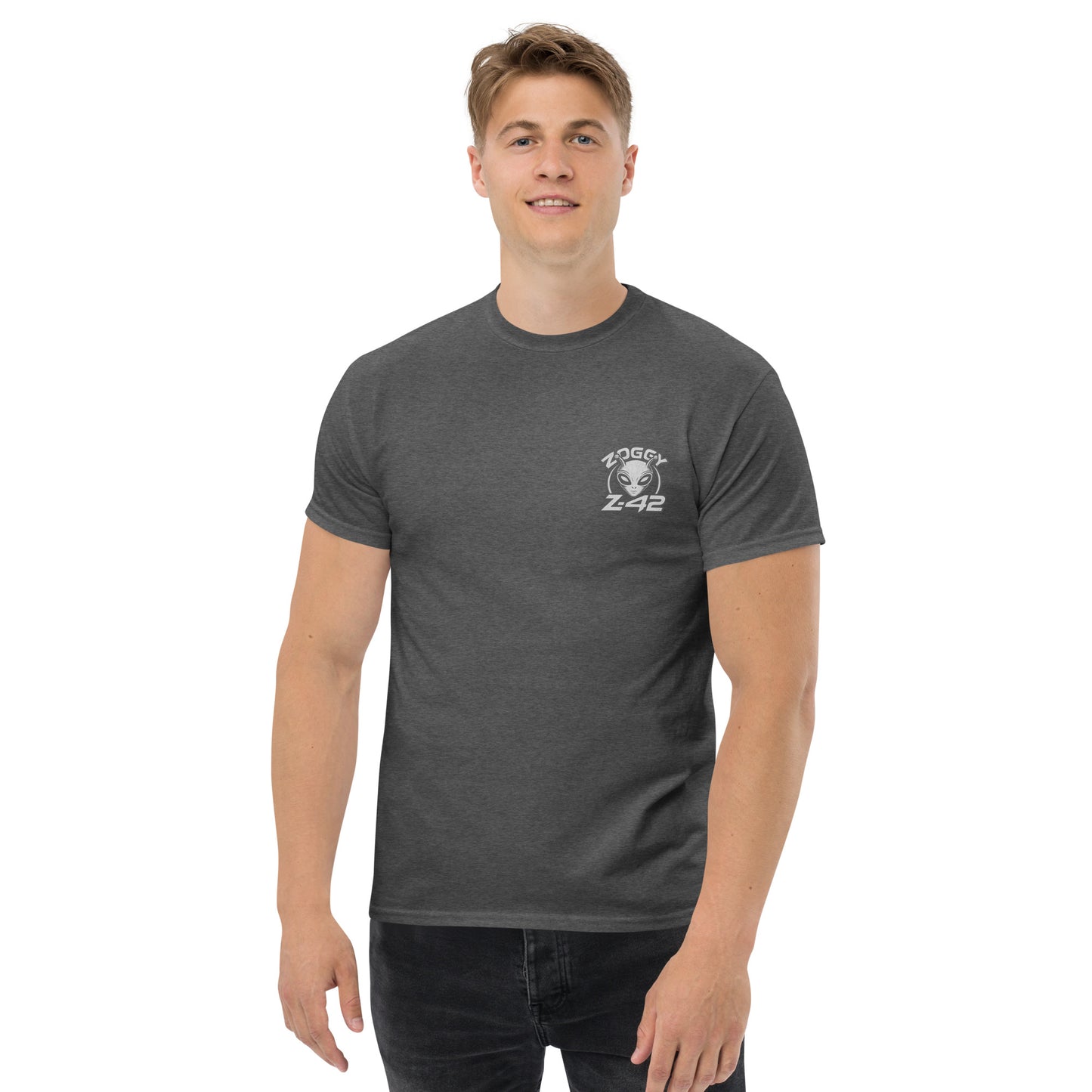 Male model wearing grey T-shirt — front print: green alien in floral frame with text ALIEN HEART