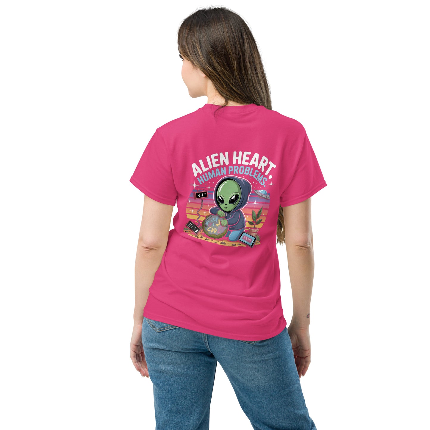 Female model wearing pink T-shirt — back print: green alien in floral frame with text ALIEN HEART