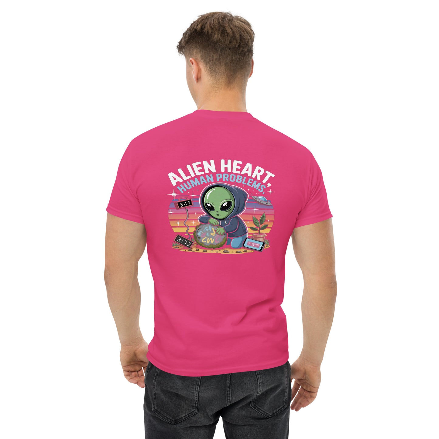 Male model wearing pink T-shirt — back print: green alien in floral frame with text ALIEN HEART