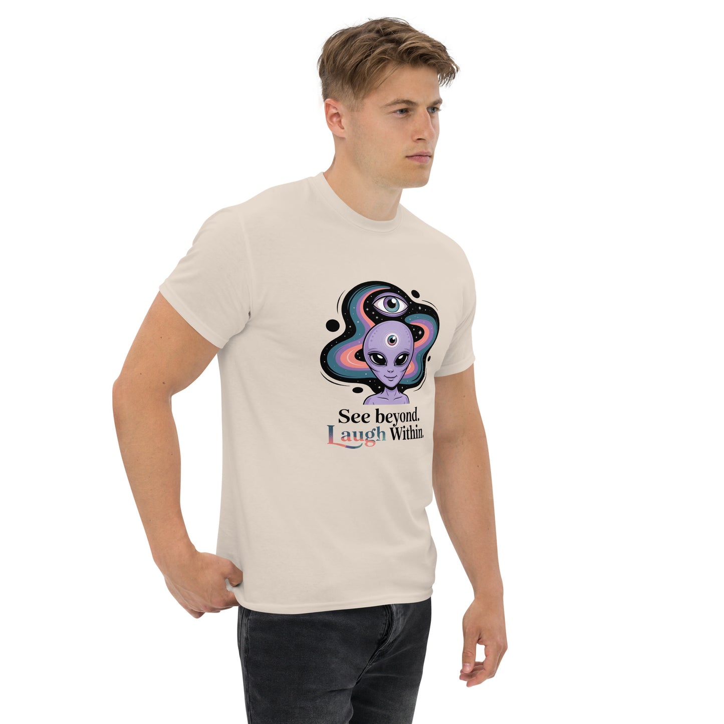 Male model wearing beige T-shirt — front print: alien in cosmic background with text See beyond, I am Within.