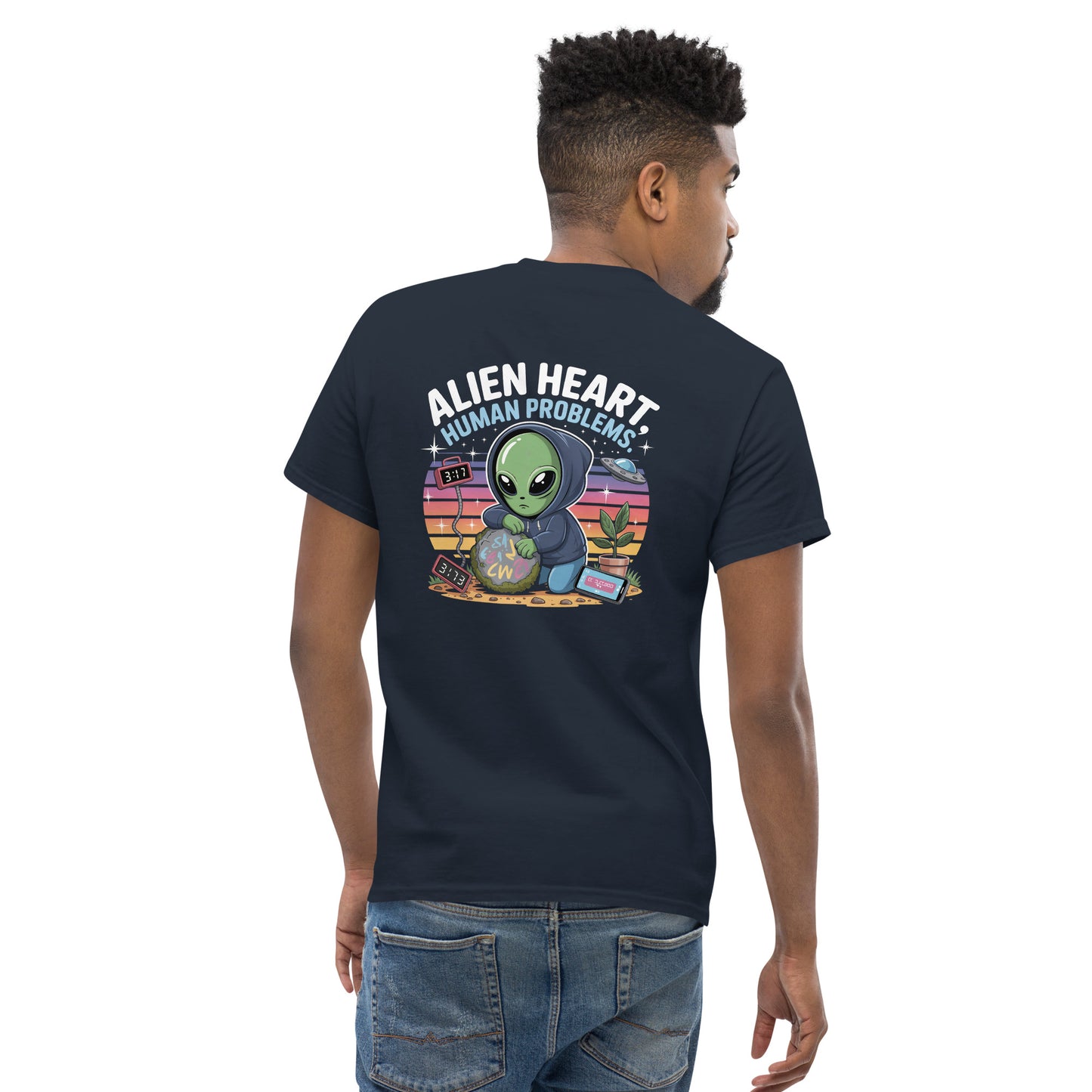 Male model wearing azul T-shirt — azul print: green alien in floral frame with text ALIEN HEART