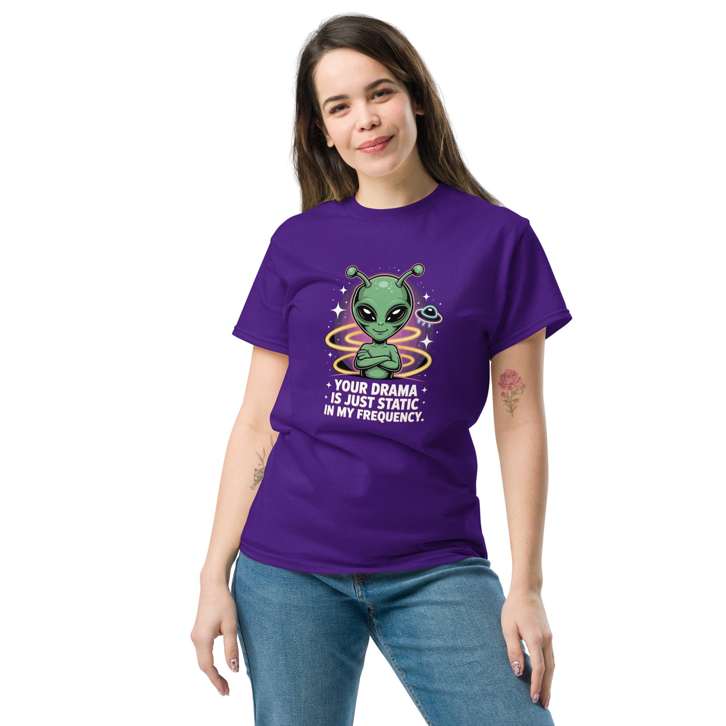Female model wearing purple T-shirt — front print: green alien with colorful background and text YOUR DRAMA IS NOT SPEAKING MY FREQUENCY