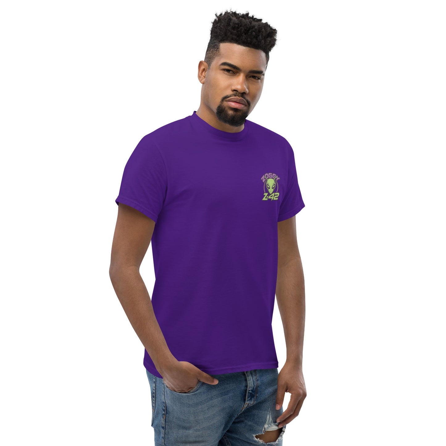 Male model wearing purple T-shirt — front left chest small alien in spaceship graphic