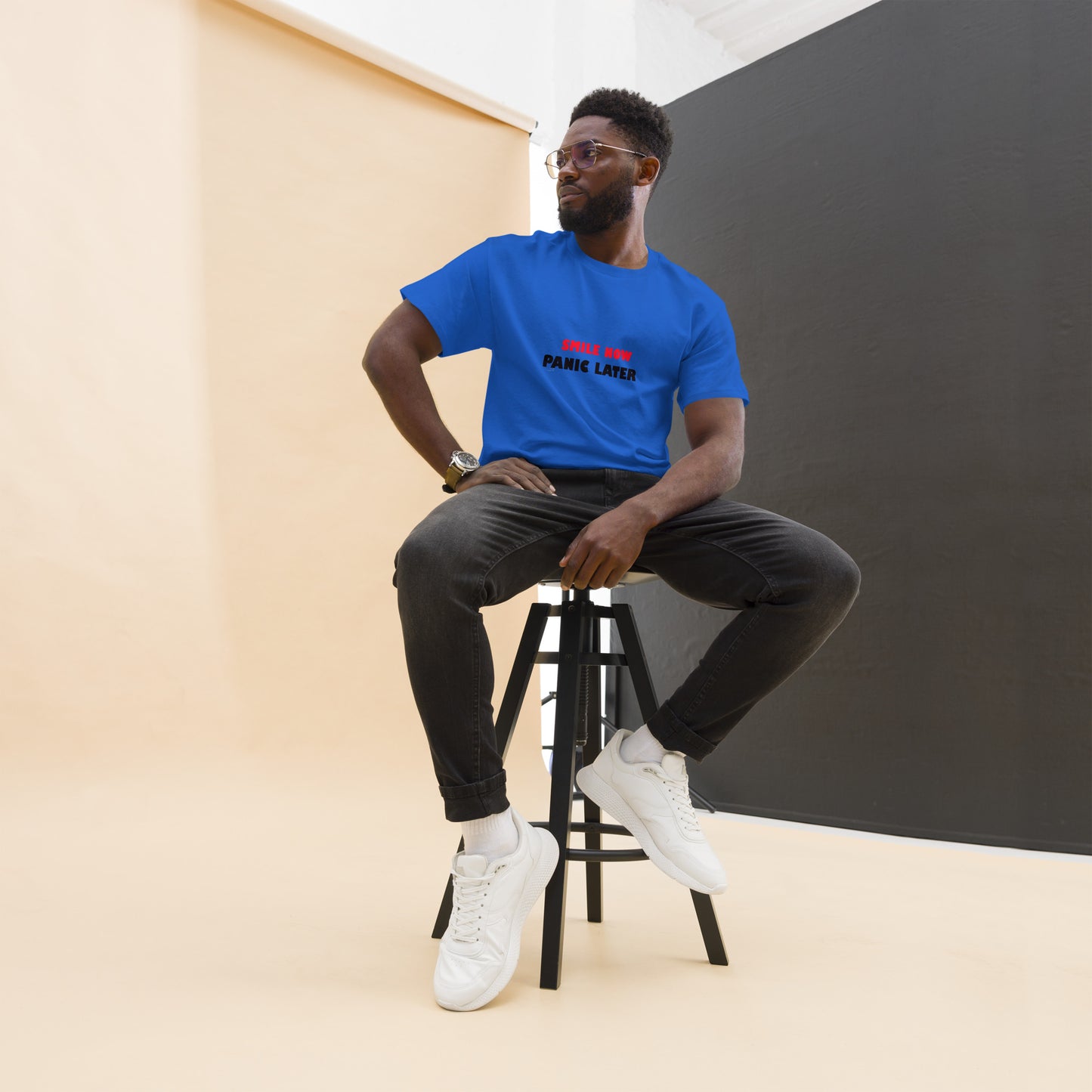 Blue unisex T-shirt with a large multicolor abstract face on the front. Colorful and bold statement piece