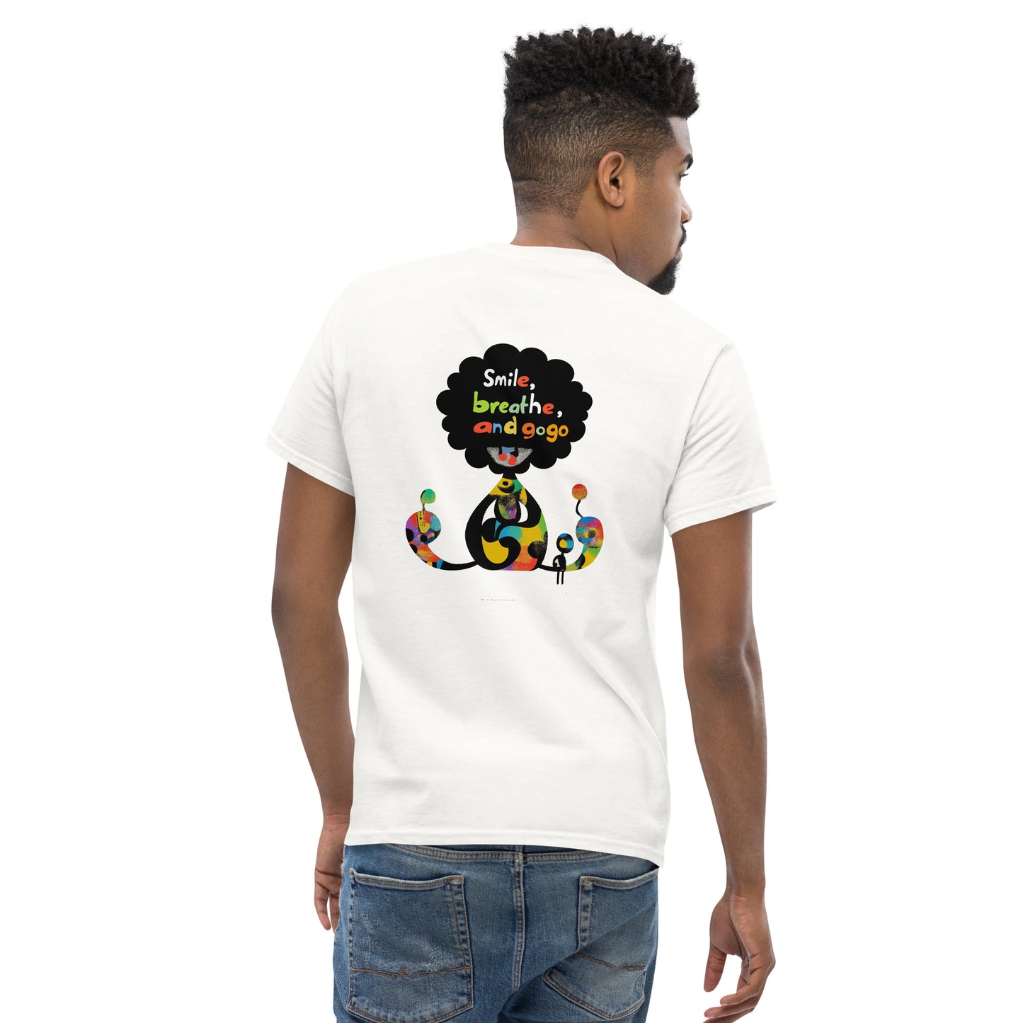 Male model wearing white T-shirt — back print: black speech bubble with text Smile, breathe, and go slowly