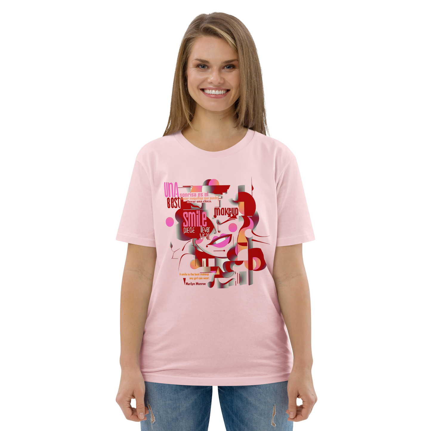 Female model wearing peach T-shirt — front print: abstract Marilyn Monroe portrait with quote “A smile is the best makeup any girl can wear. — Marilyn Monroe”