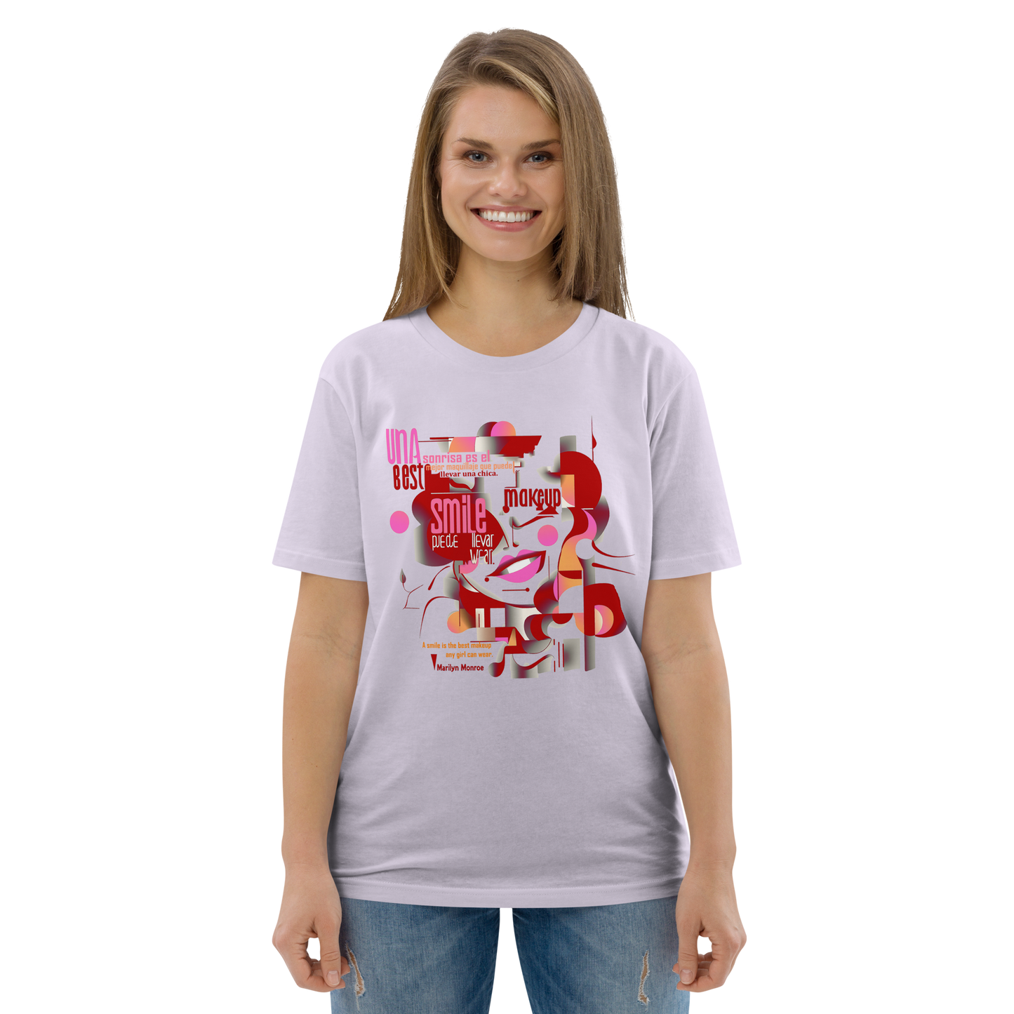 Female model wearing peach T-shirt — front print: abstract Marilyn Monroe portrait with quote “A smile is the best makeup any girl can wear. — Marilyn Monroe”