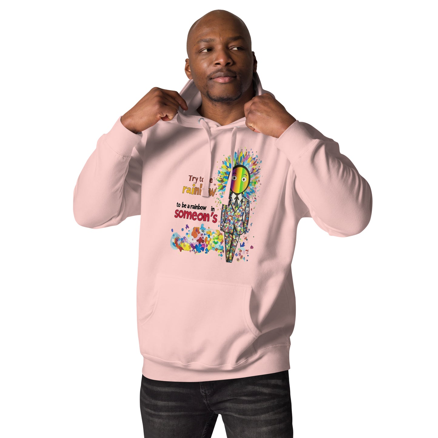 Man wearing a pink unisex hoodie featuring the Be a Rainbow illustration with colorful abstract elements, cheerful design, and positive streetwear style.