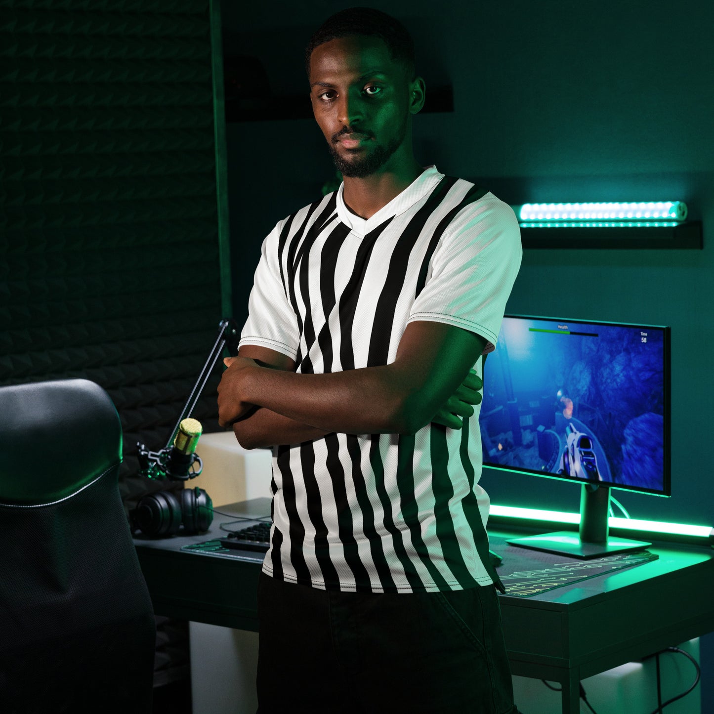 White short-sleeve T-shirt with black wavy vertical stripes, front view in gaming setup.