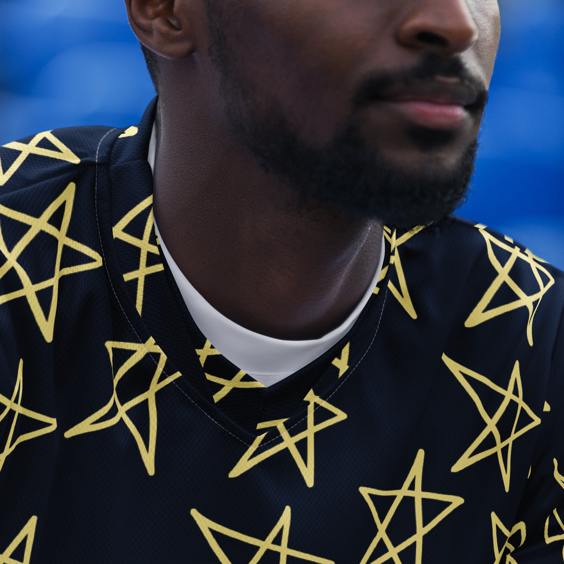 Navy short-sleeve shirt with yellow star pattern, back view without model.