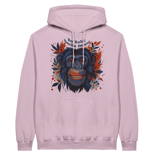 Light pink hoodie with smiling chimpanzee artwork and slogan “Be Bold, Smile More”.