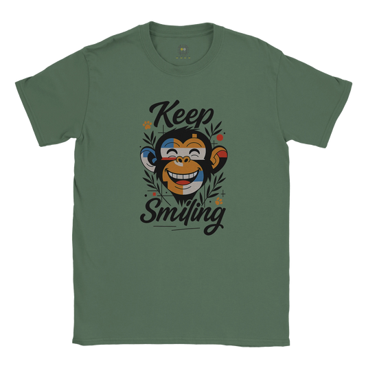 Green unisex T-shirt — front print: smiling monkey illustration with the words Keep Smiling; flat lay.