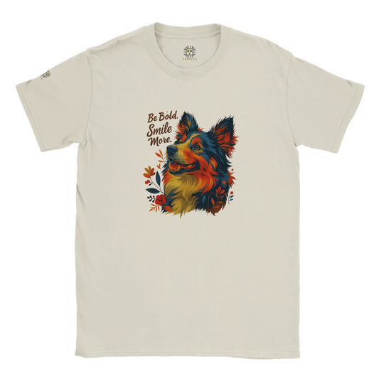 Beige T-shirt – Beige unisex graphic tee with colorful artistic dog illustration, floral accents, and motivational quote “Be Bold, Smile More.” Perfect inspirational T-shirt for dog lovers.