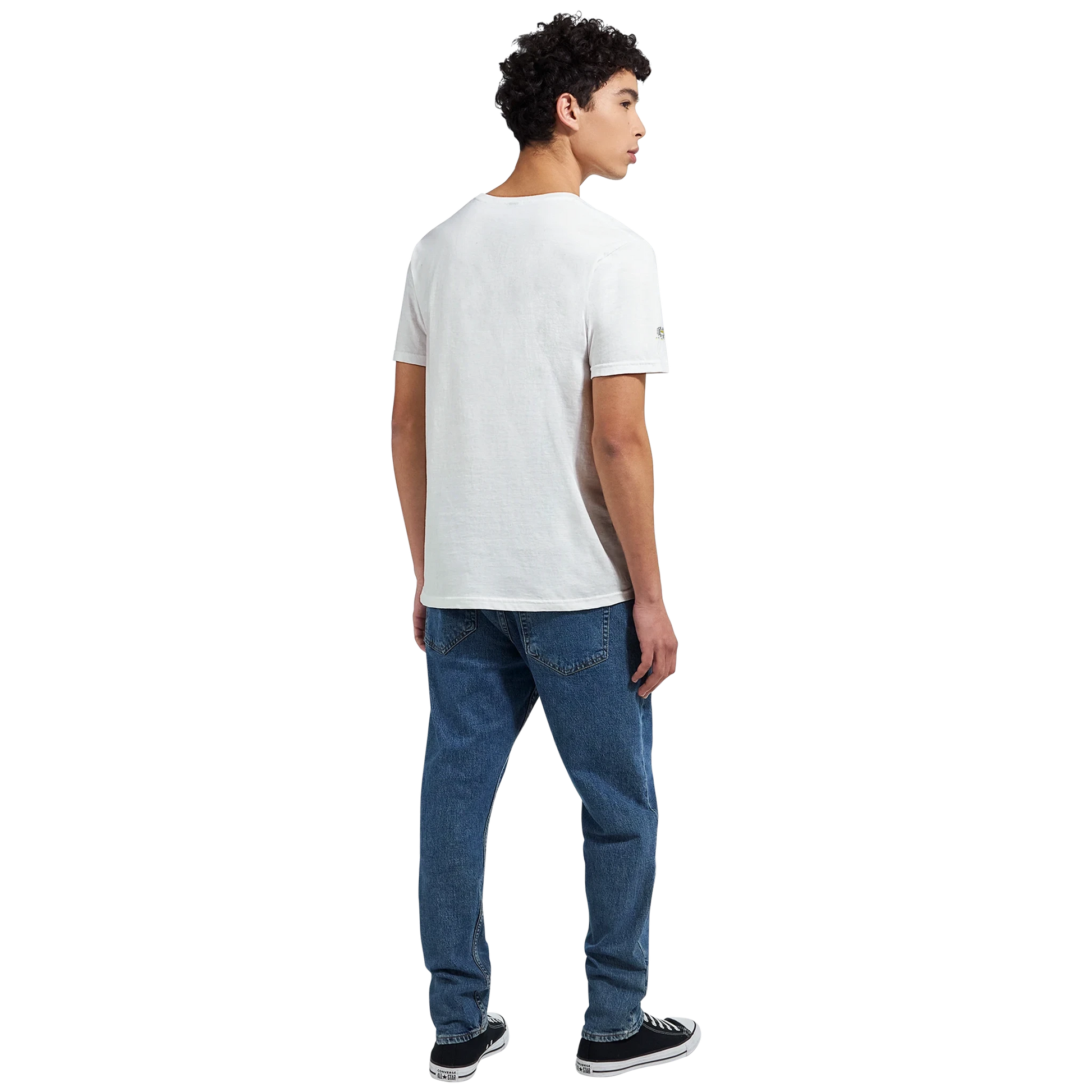 Male model wearing a white T-shirt with a chimpanzee illustration and slogan “Be Wild Stay Free,” back view.