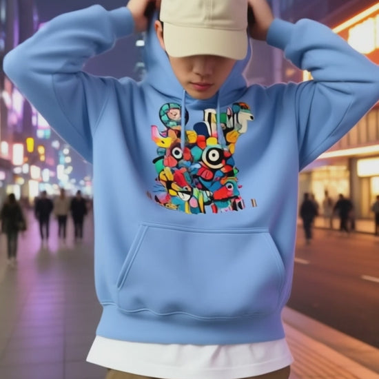 Model wearing Pekilot Japan Pop Chaos hoodie with colorful Japanese-inspired graphic in a neon Tokyo street.