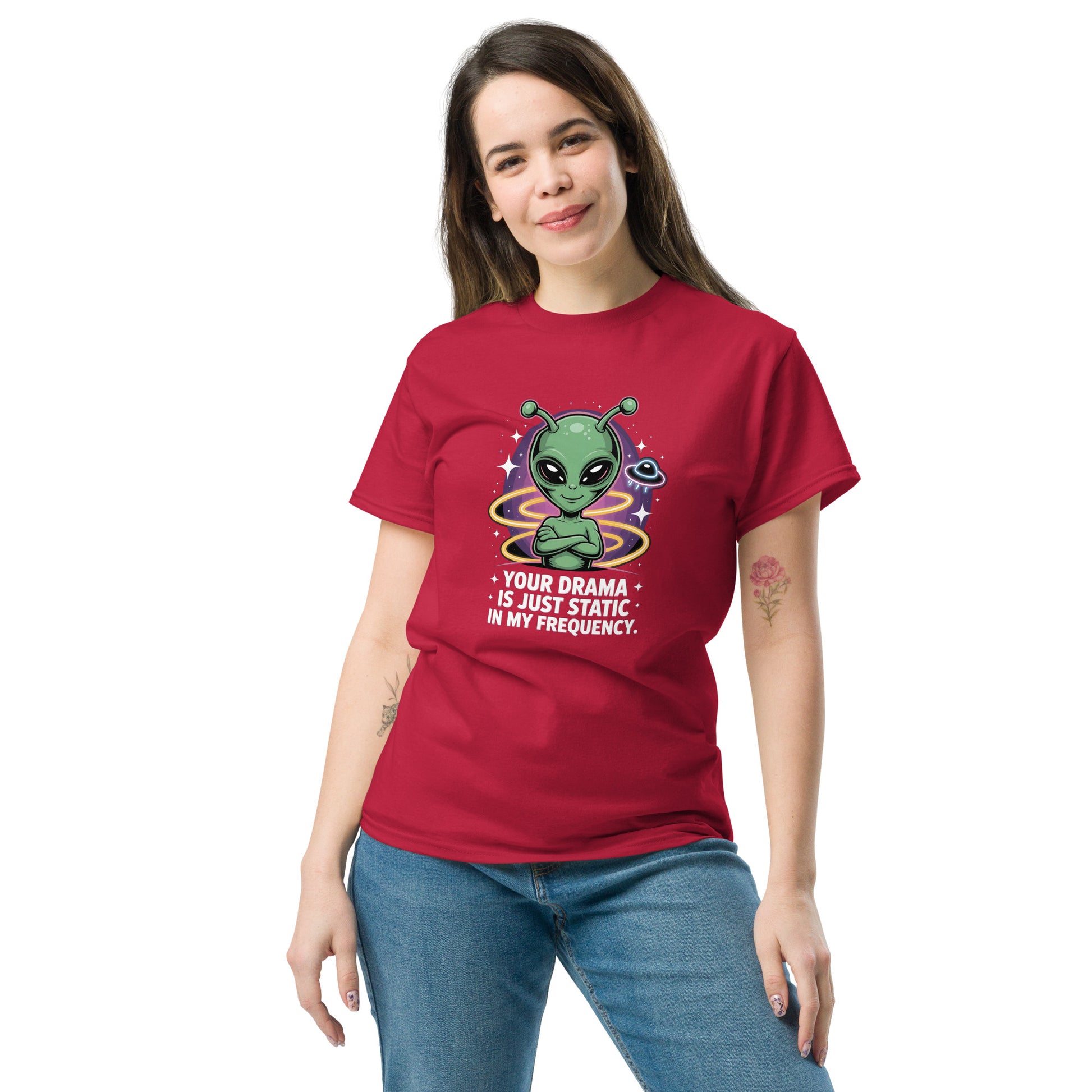 Female model wearing red T-shirt — front print: green alien with colorful background and text YOUR DRAMA IS NOT SPEAKING MY FREQUENCY