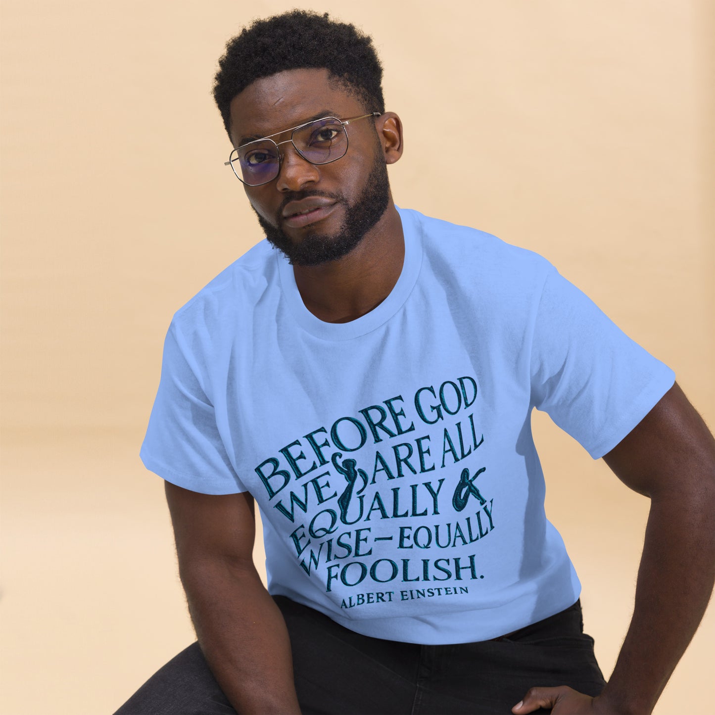 Light blue t-shirt with bold feminist quote print “Before God we are all equally wise and equally foolish” – Sisterhood Club Collection