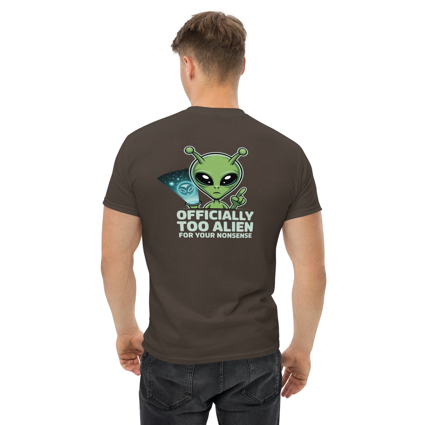 Male model wearing brown T-shirt — back print: green alien with text OFFICIALLY TOO ALIEN FOR YOU HUMANS