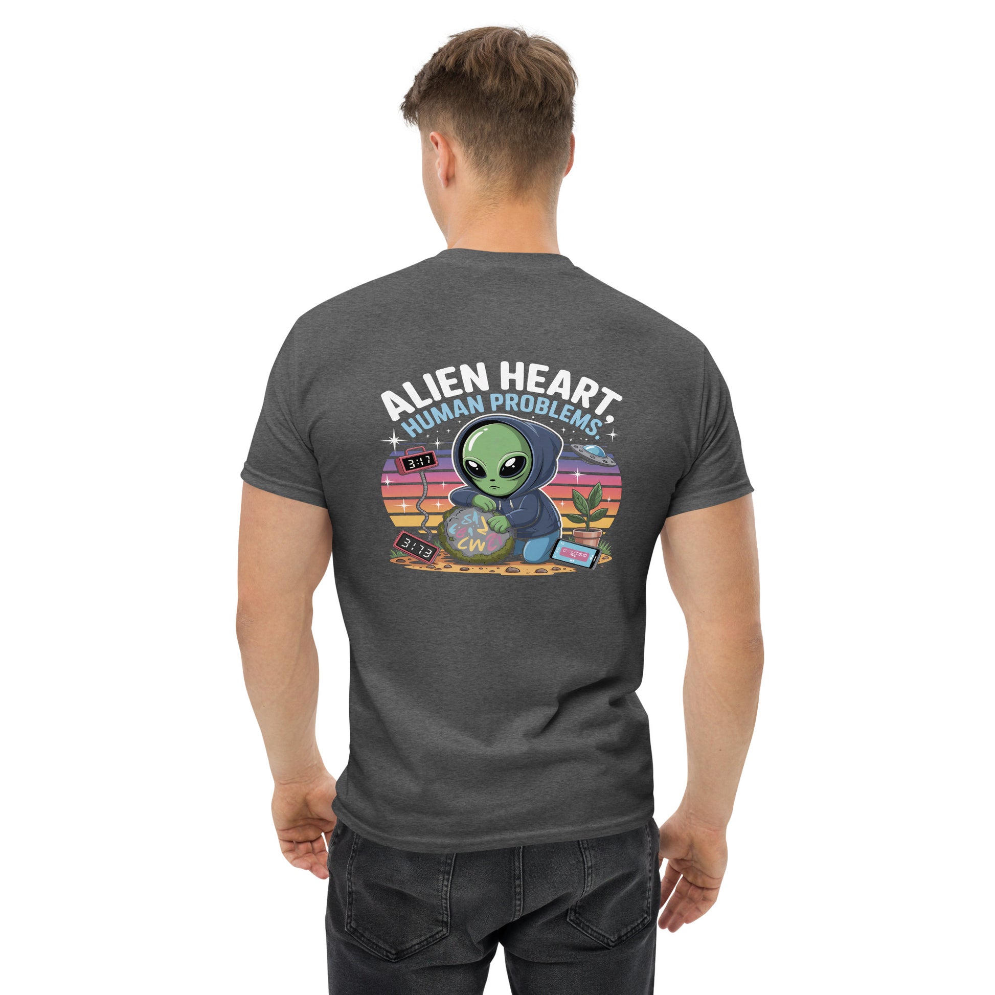 Male model wearing grey T-shirt — back print: green alien in floral frame with text ALIEN HEART