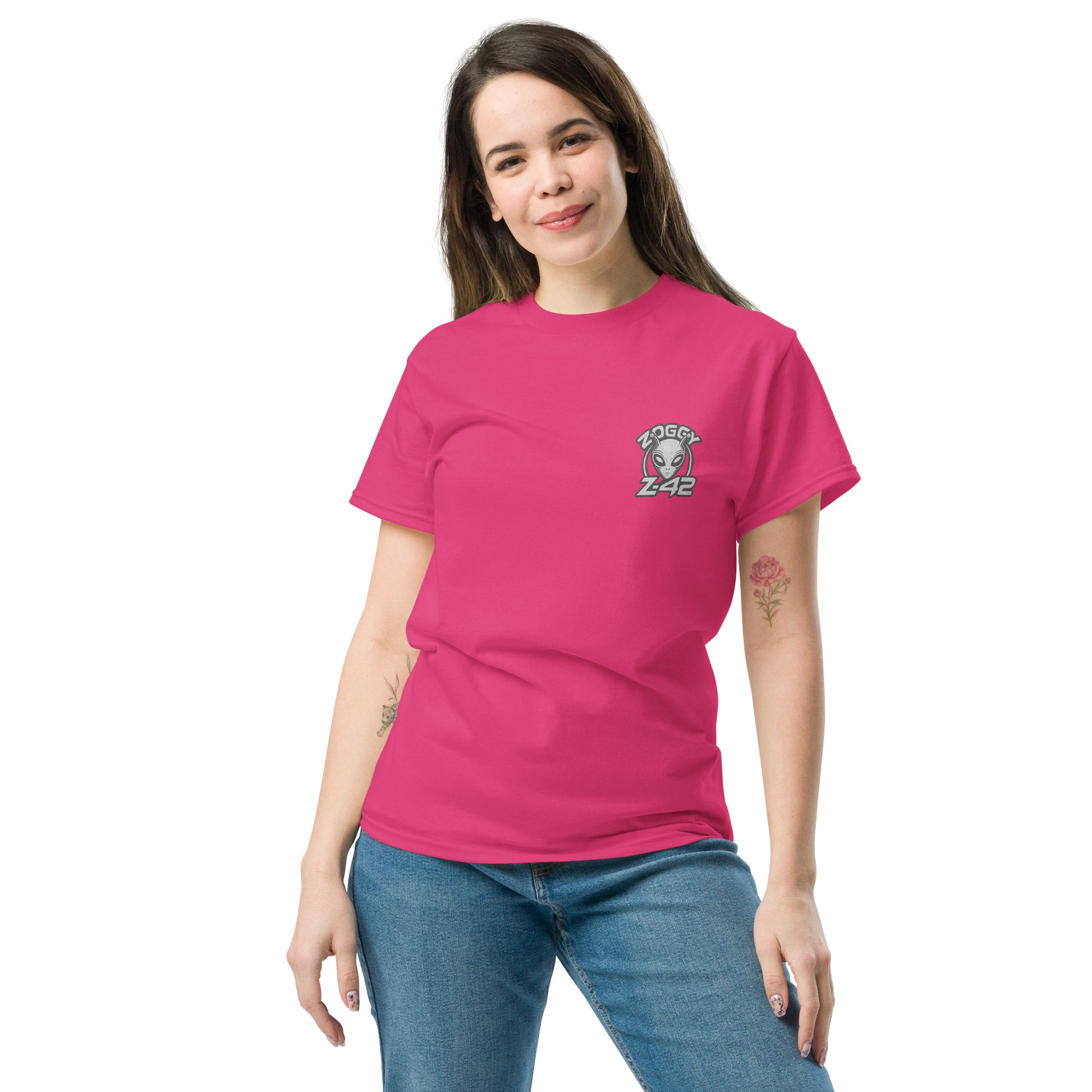 Female model wearing pink T-shirt — front left chest small alien head graphic with floral frame