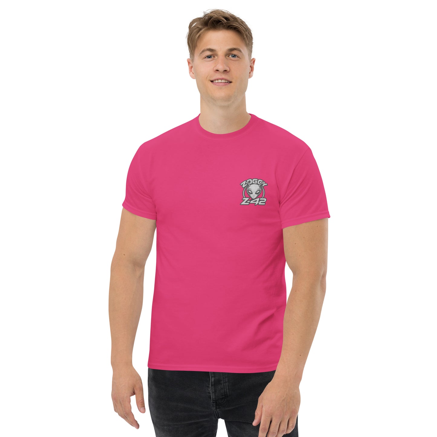 Male model wearing pink T-shirt — front left chest small alien head graphic with floral frame
