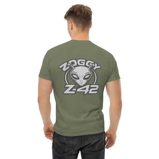 Male model wearing olive green T-shirt — back print: large grey alien head with text ZOGGY Z-42