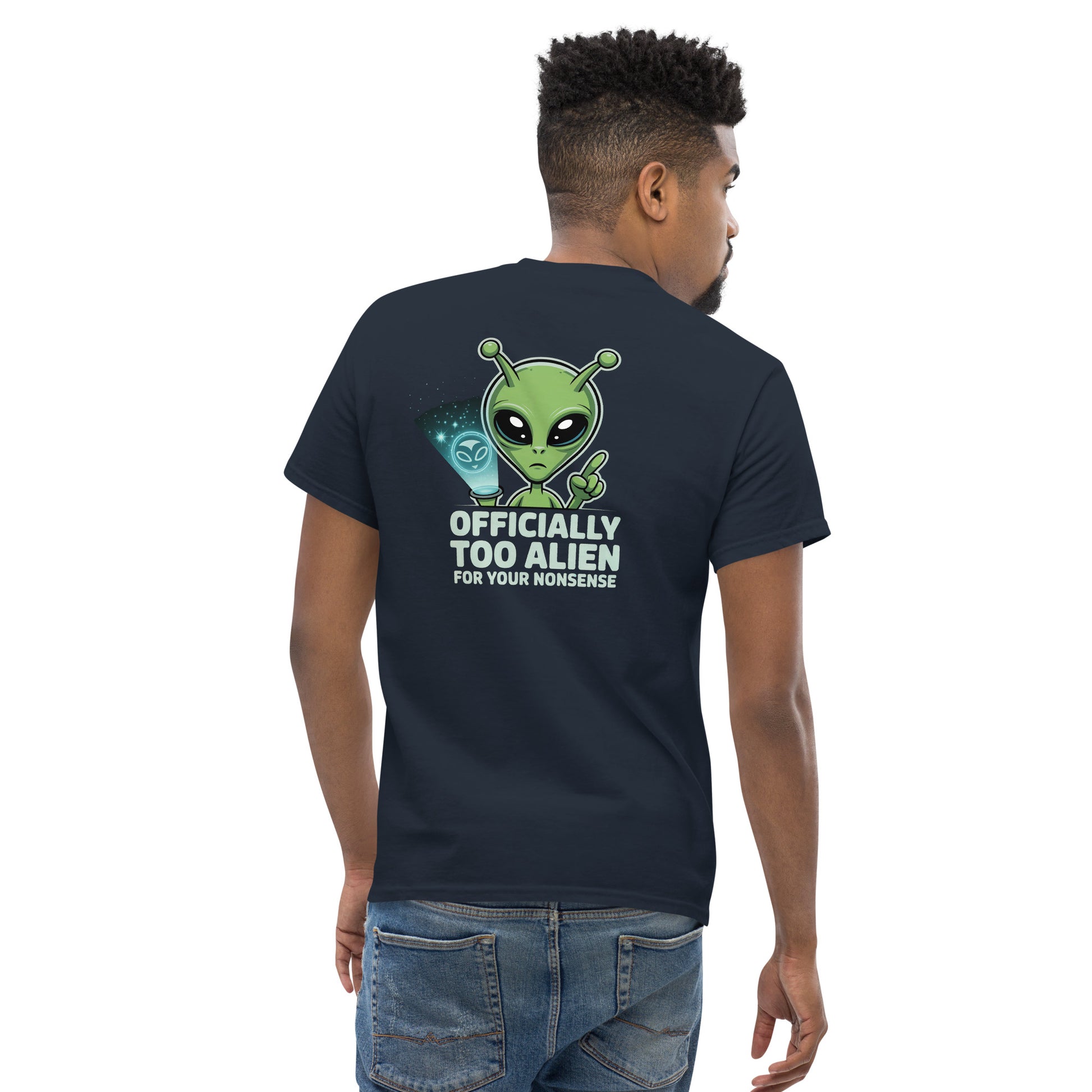 Male model wearing navy blue T-shirt — back print: green alien with text OFFICIALLY TOO ALIEN FOR YOU HUMANS