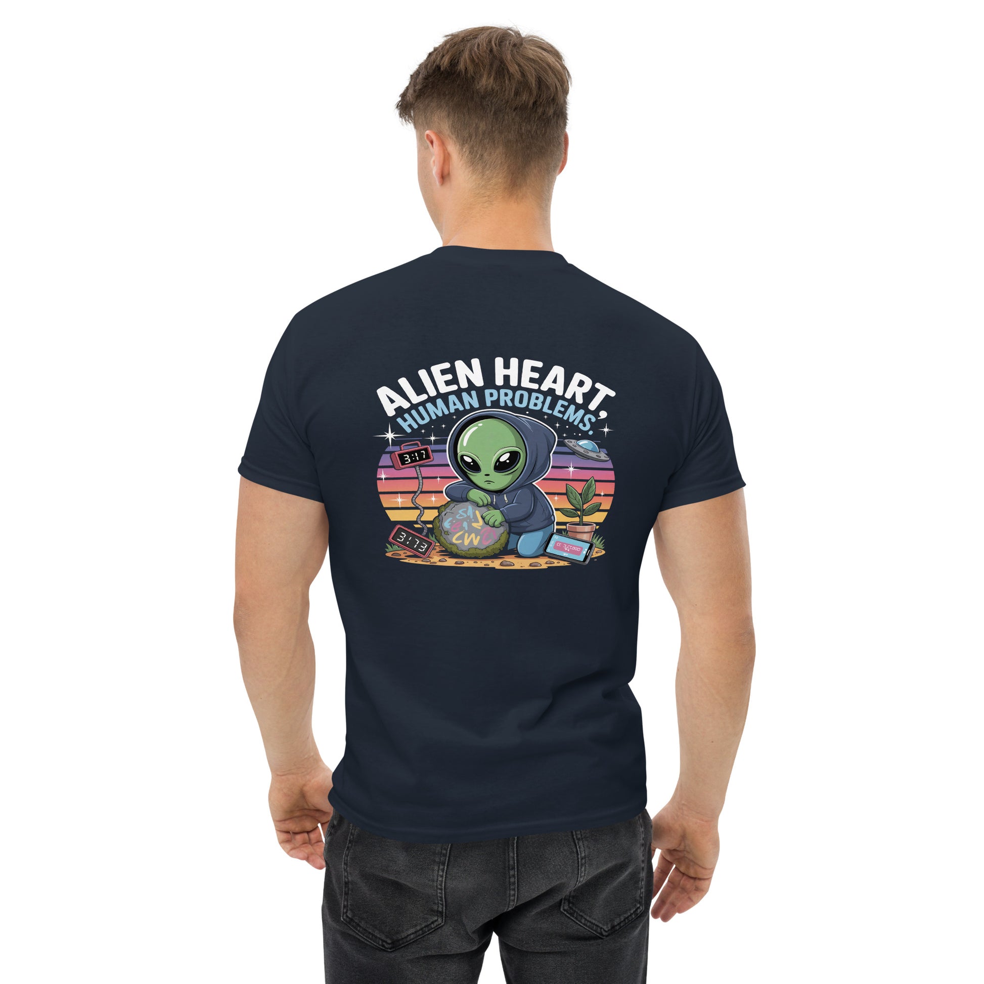 Male model wearing navy blue T-shirt — back print: green alien in floral frame with text ALIEN HEART