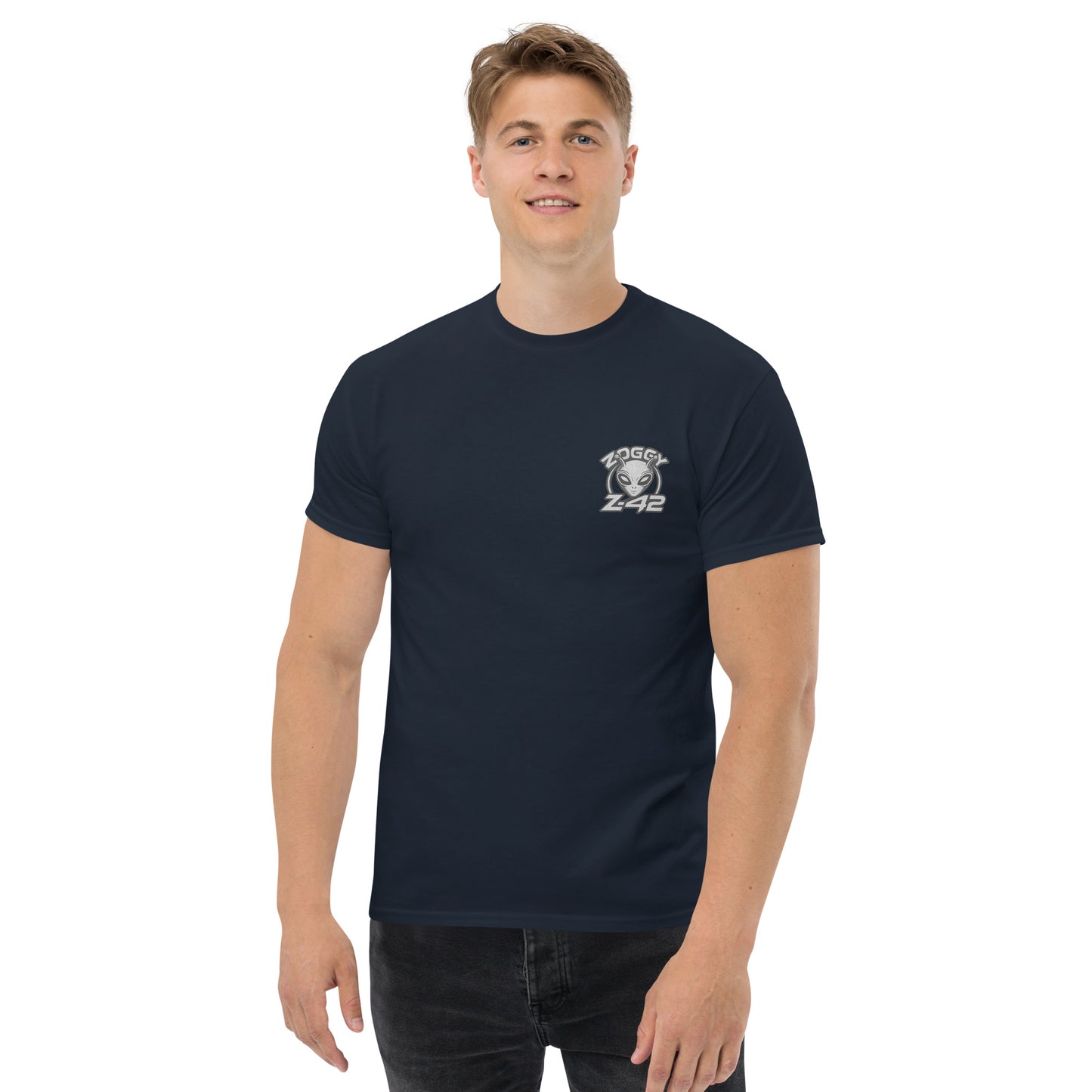 Male model wearing navy blue T-shirt — front left chest small alien head graphic with floral frame
