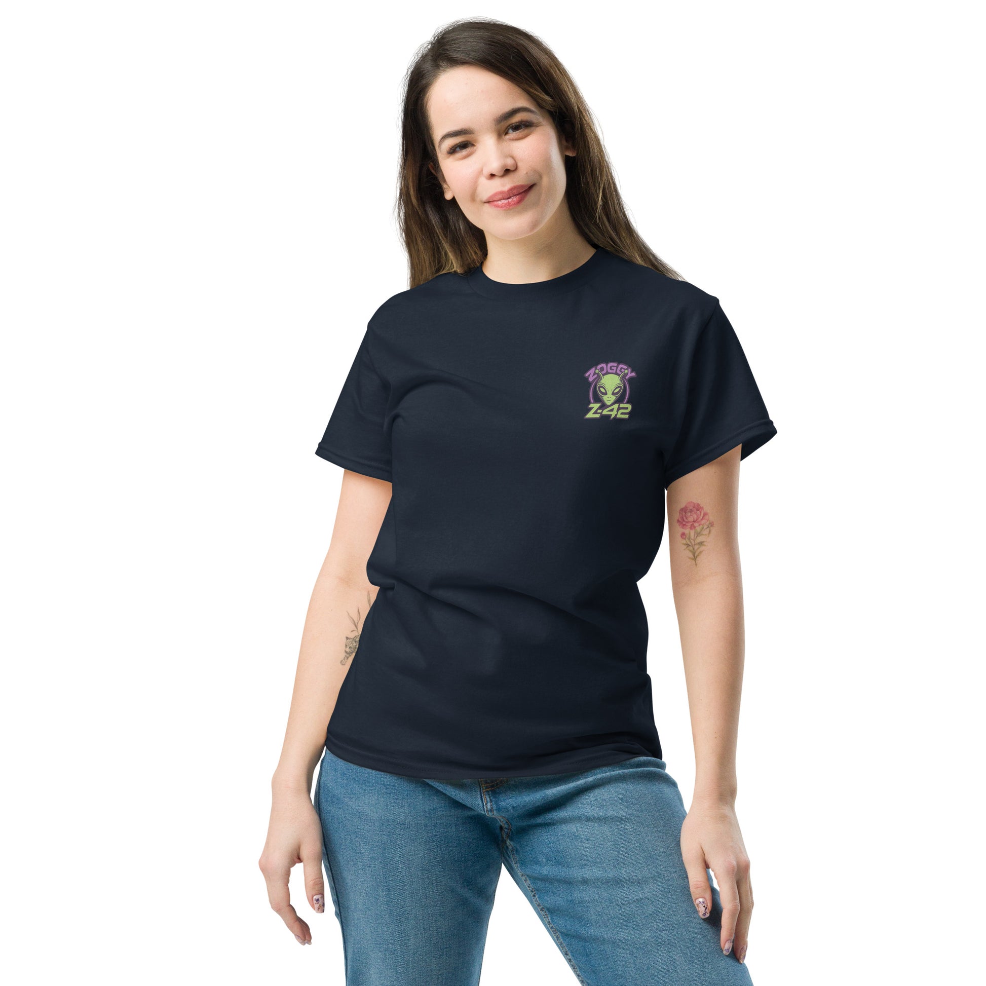Female model wearing black T-shirt — front left chest small alien head graphic