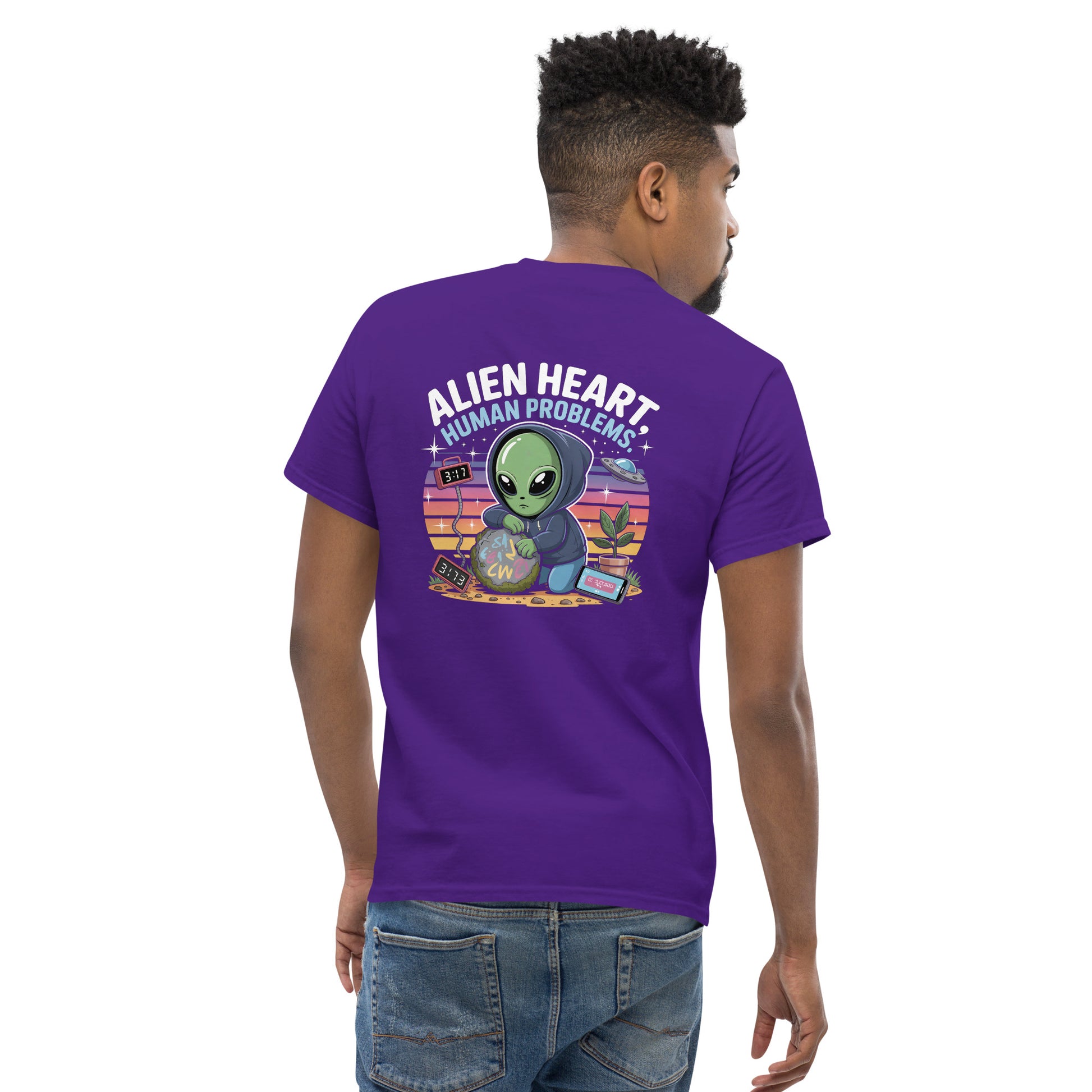 Male model wearing purple T-shirt  purporv— back print: green alien in floral frame with text ALIEN HEART