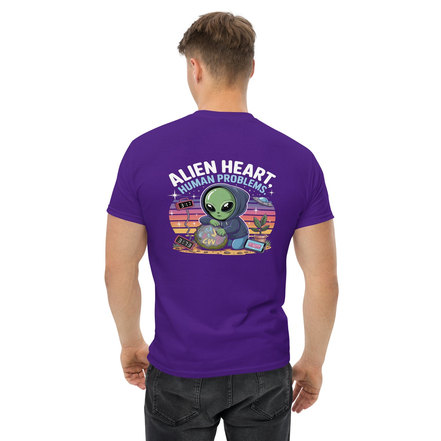 Male model wearing purple T-shirt — front left chest small alien head graphic with floral frame