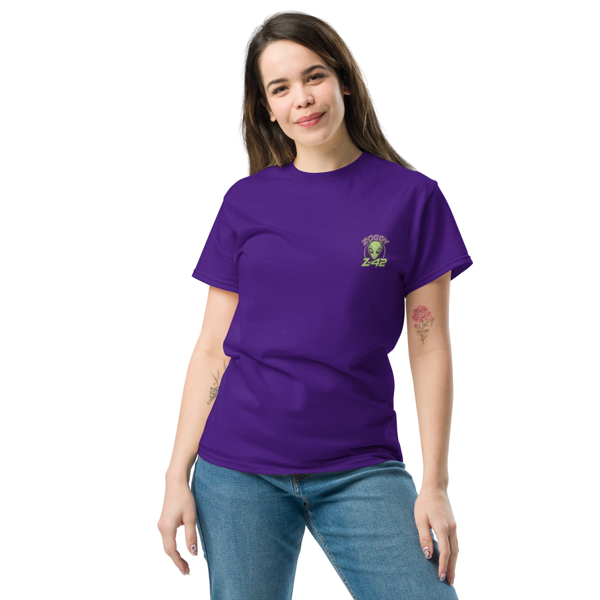 Female model wearing purple T-shirt — front left chest small alien head graphic