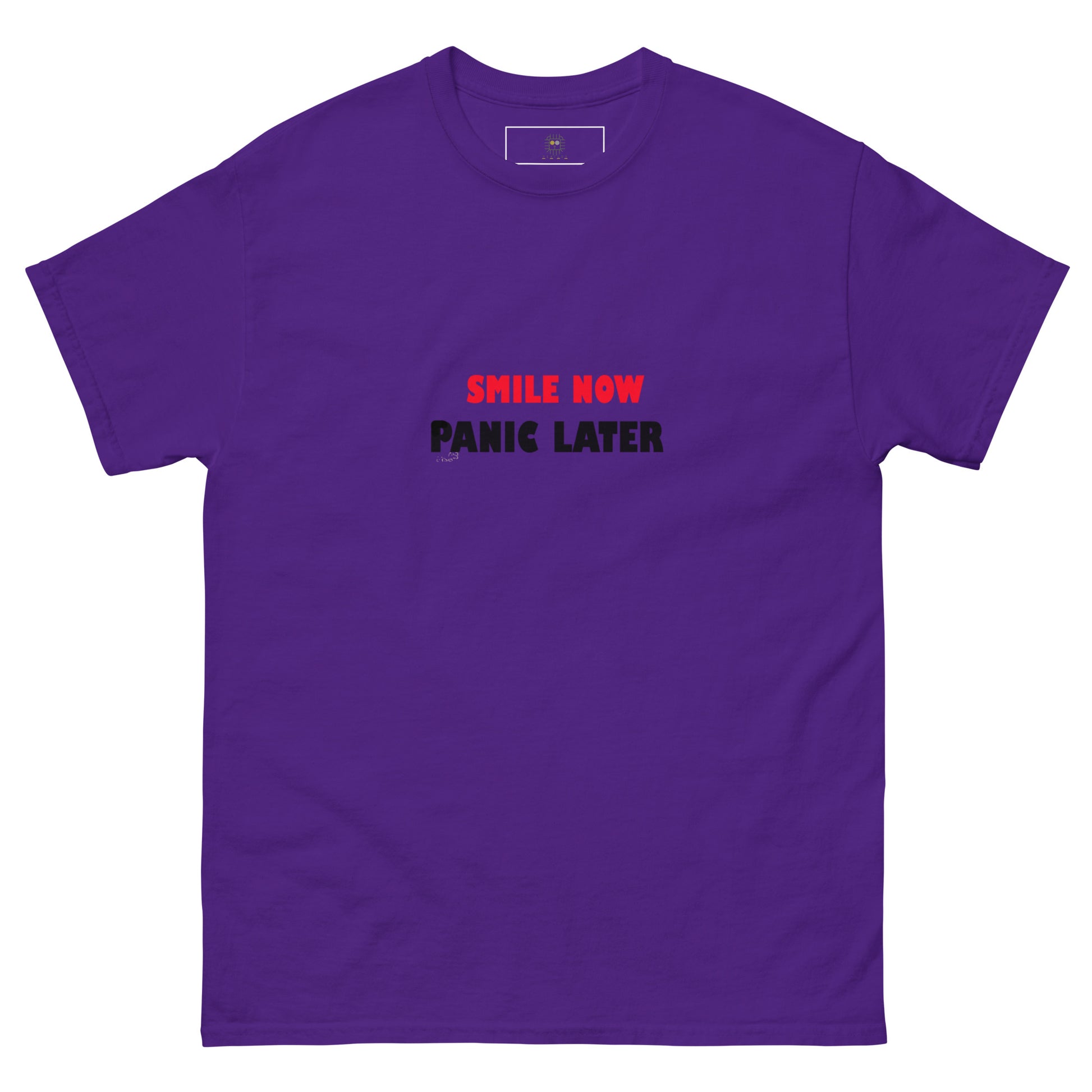 Purple unisex T-shirt with bold red 'Smile Now Panic Later' text on the front. Minimalist statement style