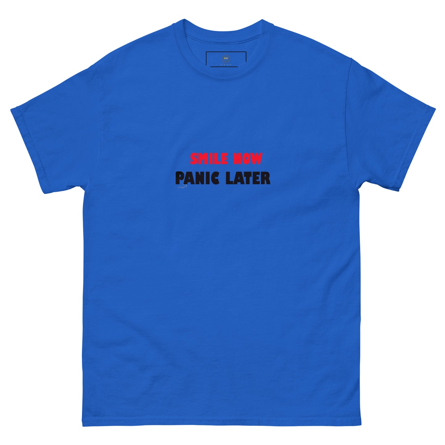 Blue T-shirt with 'Smile Now Panic Later' in red on the front. Minimalist yet expressive style