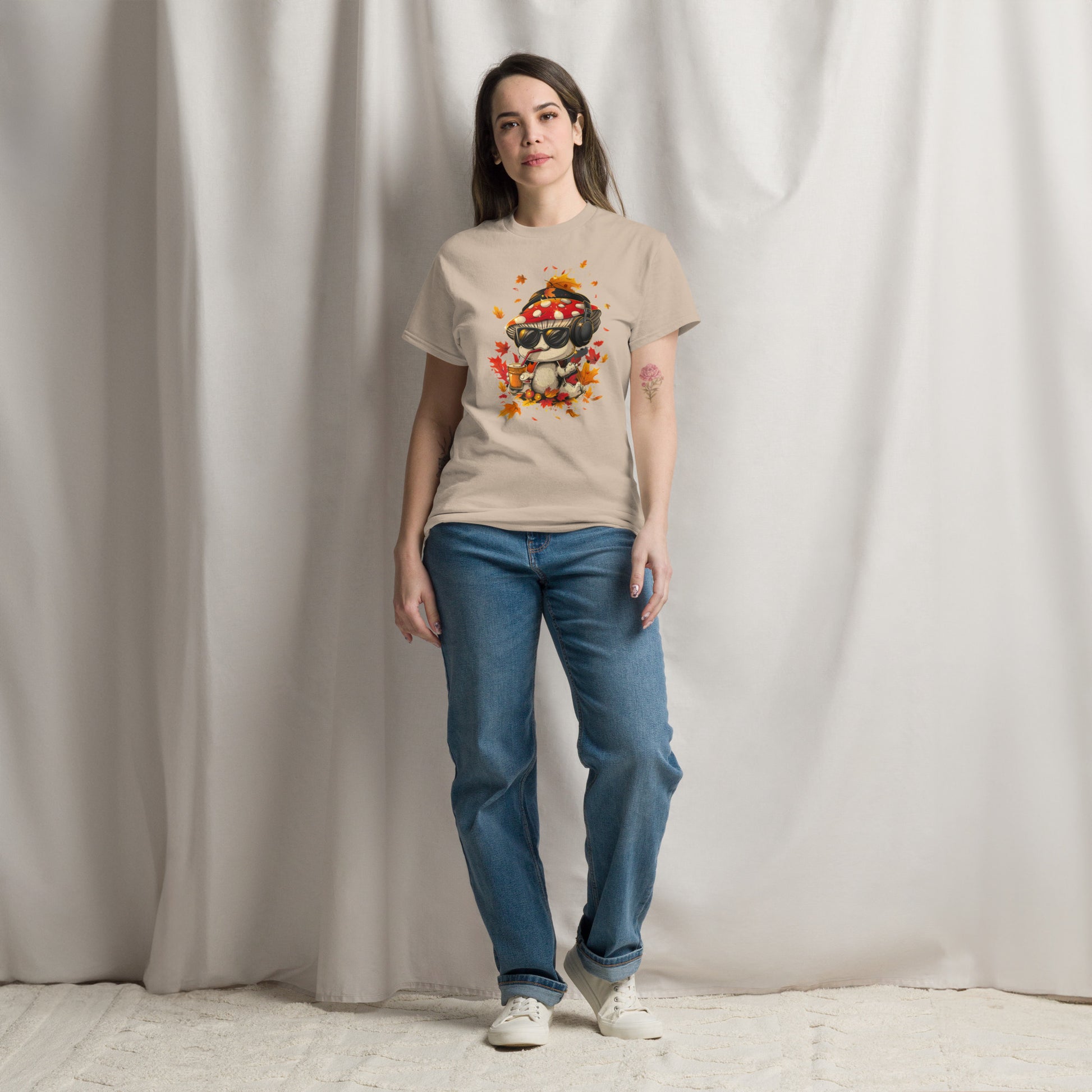 Female model in a beige t-shirt with mushroom character and leaves print.