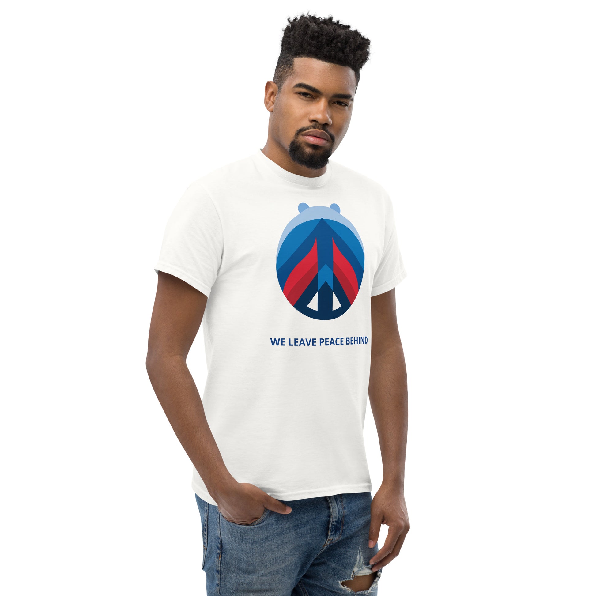 Model wearing a white graphic t-shirt with the “WE LEAVE PEACE BEHIND” statement.
The centered front print remains clear and balanced, maintaining a restrained visual presence within a clean silhouette.