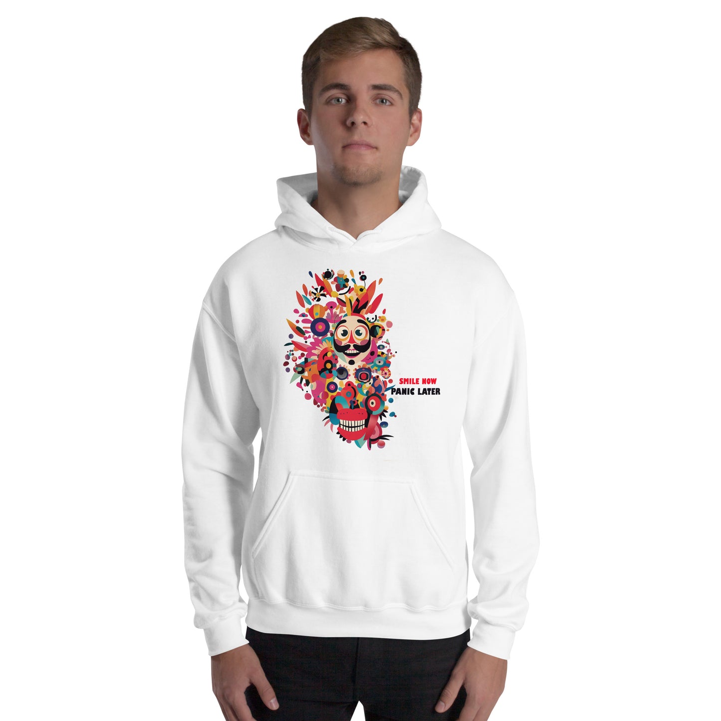 Man wearing a white unisex hoodie featuring the Smile Now Panic Later artwork with colorful abstract flowers, cheerful character design, and artistic streetwear style.