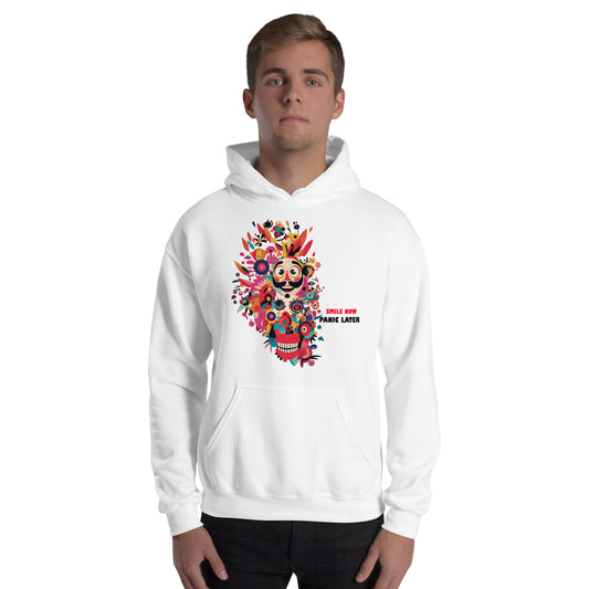 Man wearing a white unisex hoodie featuring the Smile Now Panic Later artwork with colorful abstract flowers, cheerful character design, and artistic streetwear style.