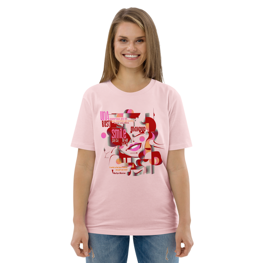 Female model wearing peach T-shirt — front print: abstract Marilyn Monroe portrait with quote “A smile is the best makeup any girl can wear. — Marilyn Monroe”