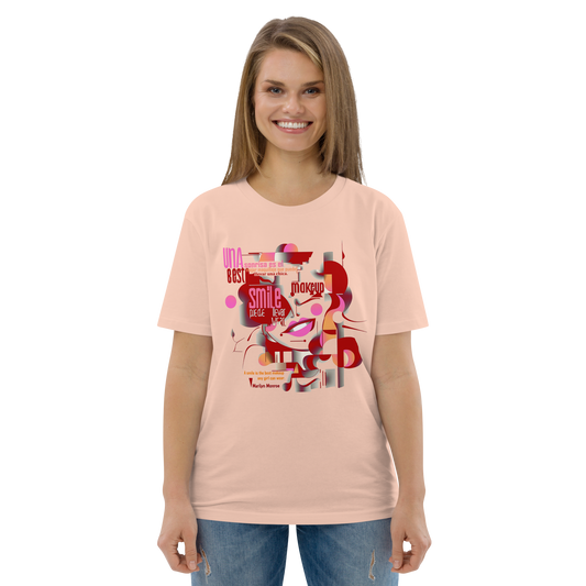 Peach unisex T-shirt — front print: abstract Marilyn Monroe portrait with text “A smile is the best makeup any girl can wear. — Marilyn Monroe”