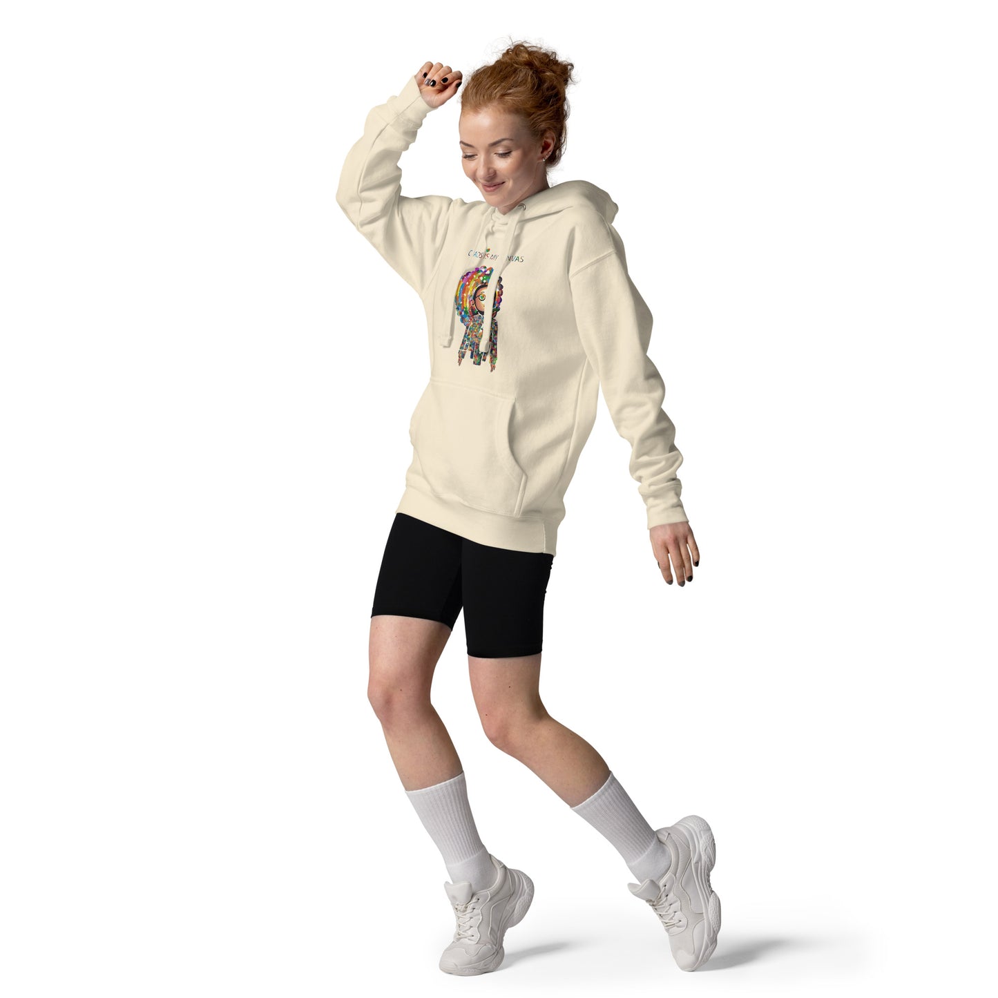 Person wearing a cream unisex hoodie with the Be a Rainbow illustration, showcasing a playful and energetic streetwear look.