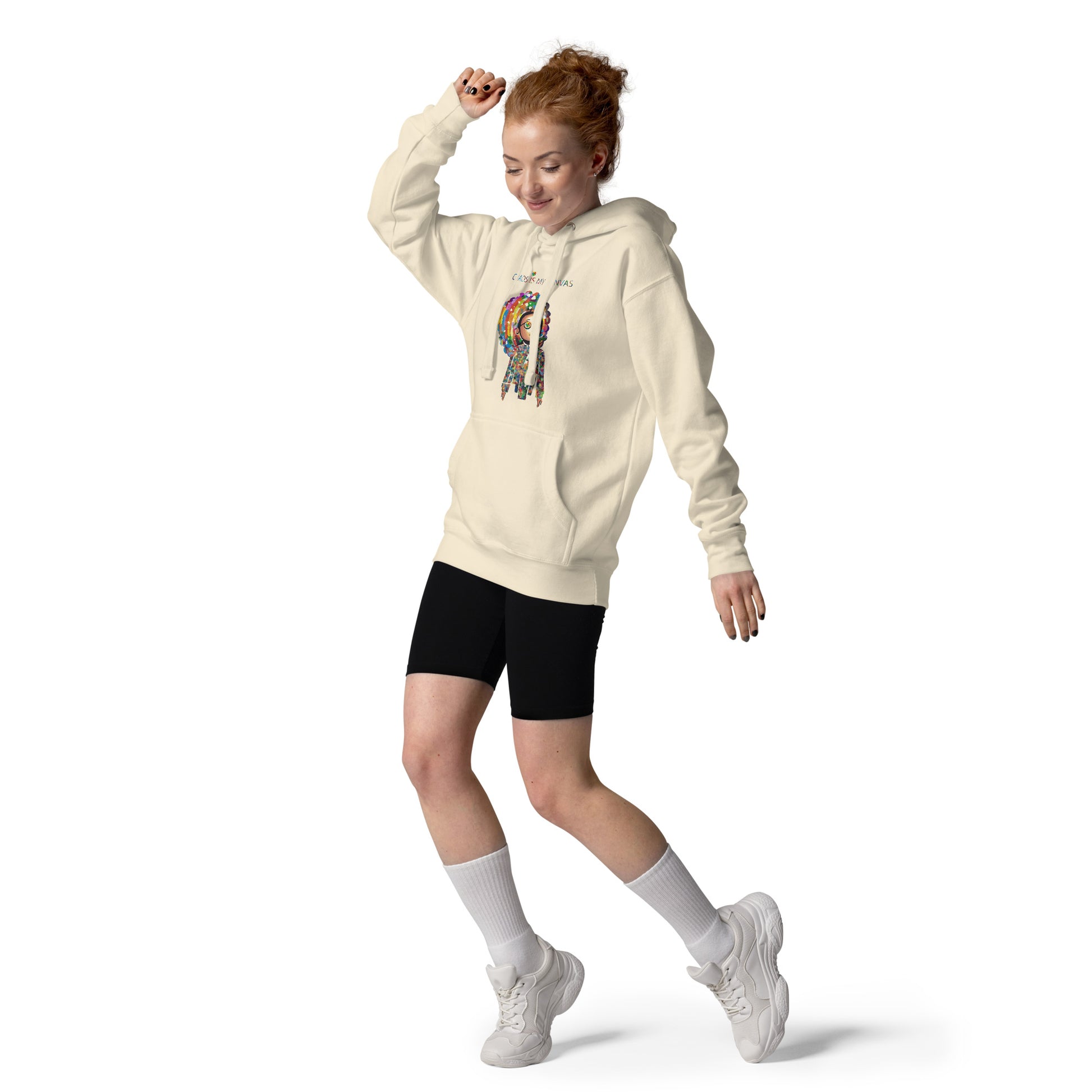 Person wearing a cream unisex hoodie with the Be a Rainbow illustration, showcasing a playful and energetic streetwear look.